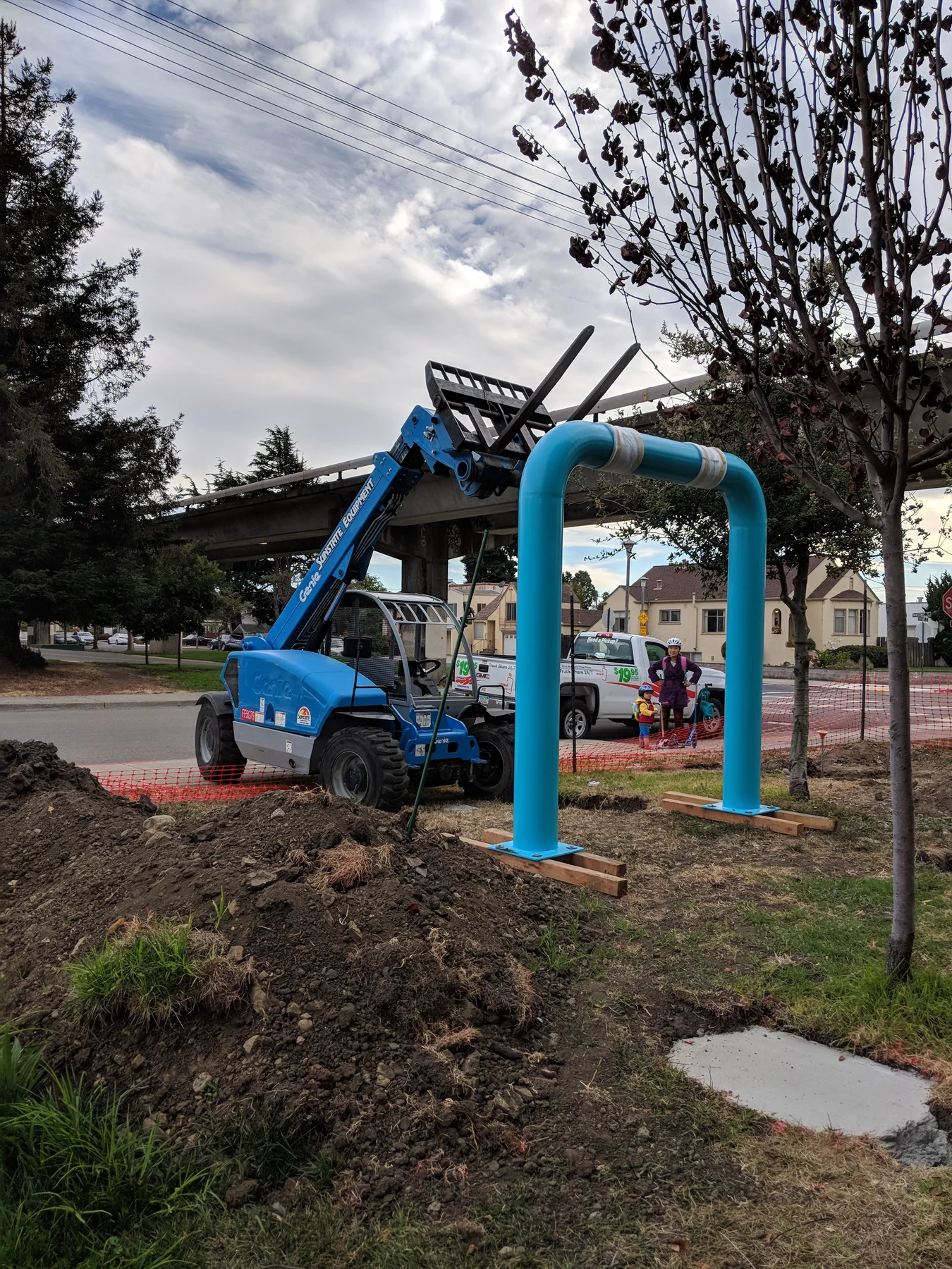Telehandler setting a blue Albany Loop pipe form into the prepared site
